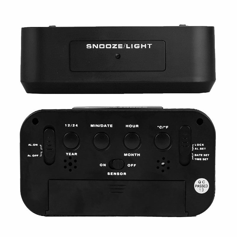 Top snooze and light button and rear controls of the black digital alarm clock